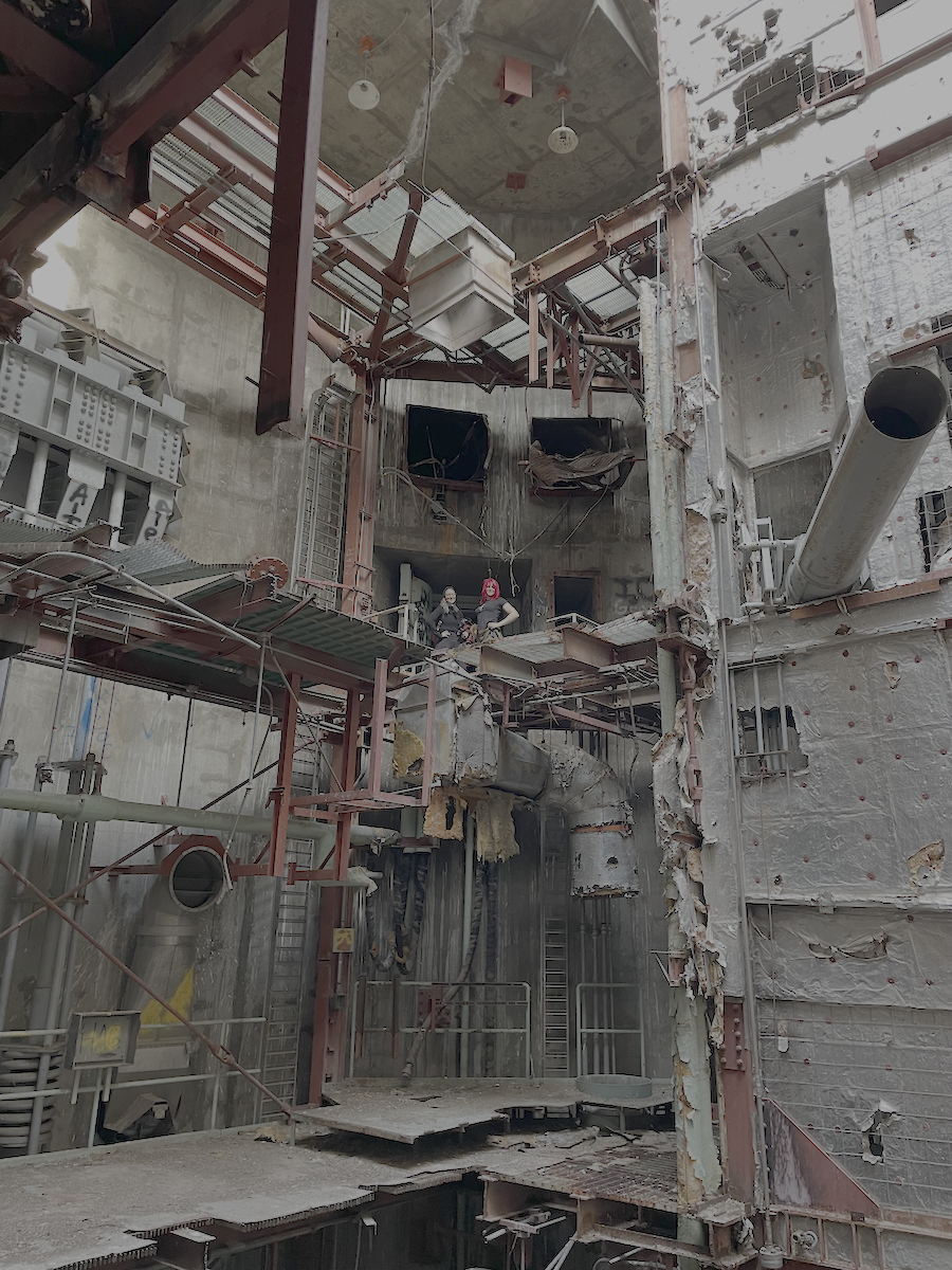 A photograph of Juno and another person standing in the ruins of an Atlas F missile silo
